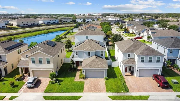 an aerial view of multiple houses with a yard