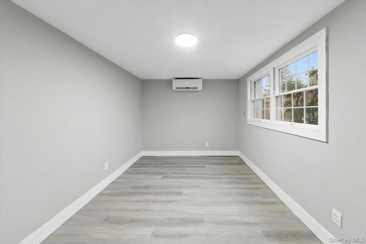 96 Fairmont Road Mahopac, NY 10541 - Photo 25 of 34 Bright 4th bedroom (basement) with wood-finish flooring and light gray walls