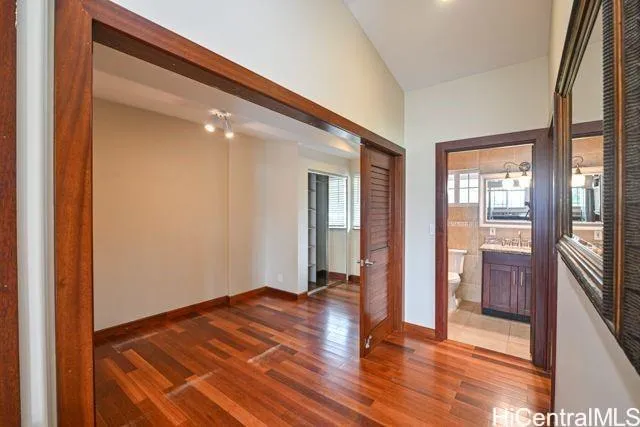 a view of a room with wooden floor and a window