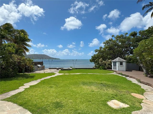 a view of lake from balcony with furniture