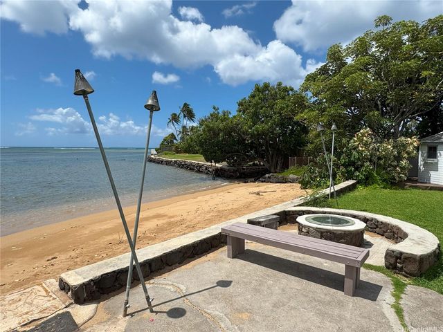 a view of house with a garden and pathway