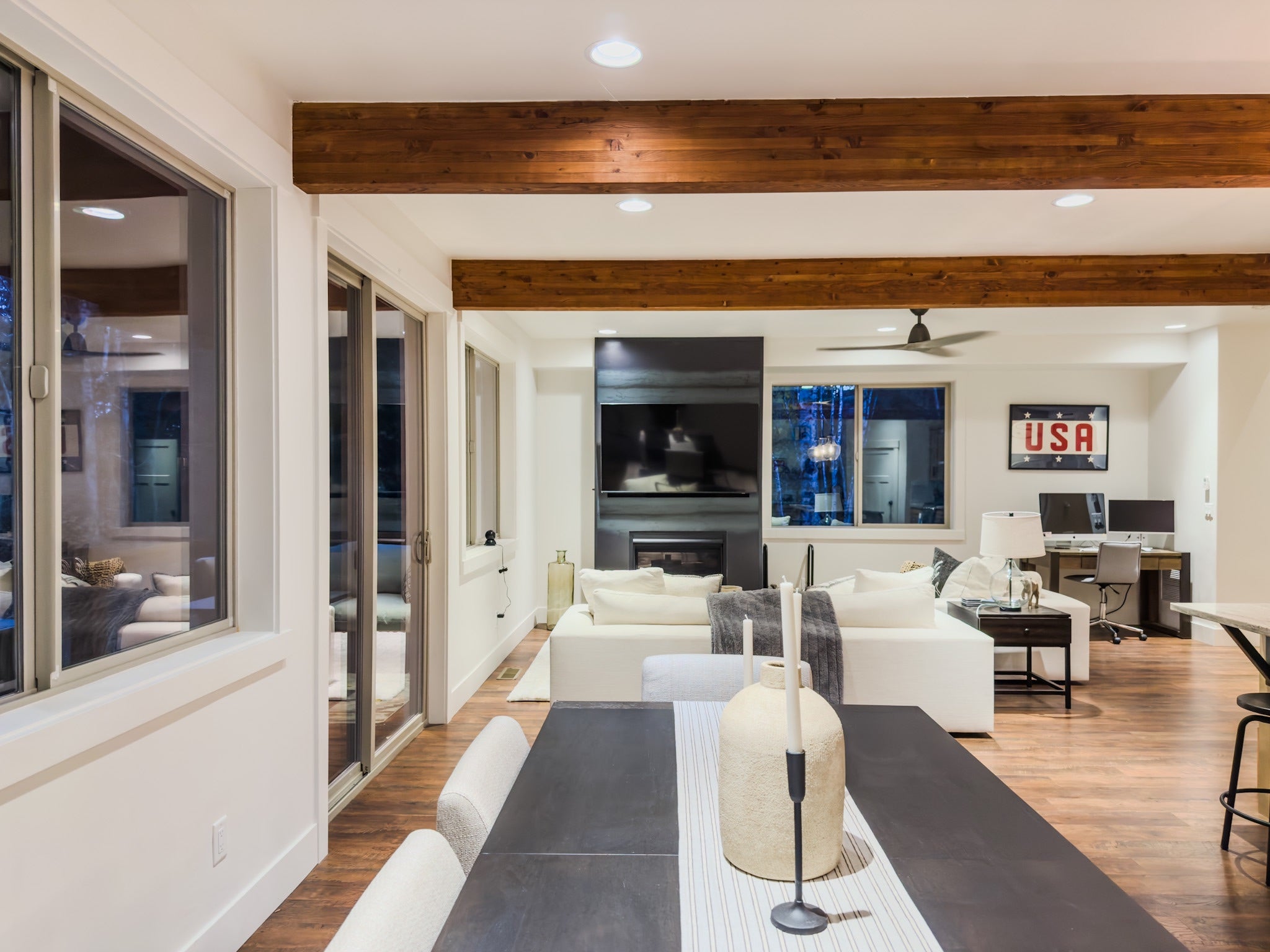 717 Icehouse Road Whitefish, MT 59937 - Photo 10 of 31 Living area featuring beam ceiling, light wood-type flooring, recessed lighting, a fireplace, and a desk
