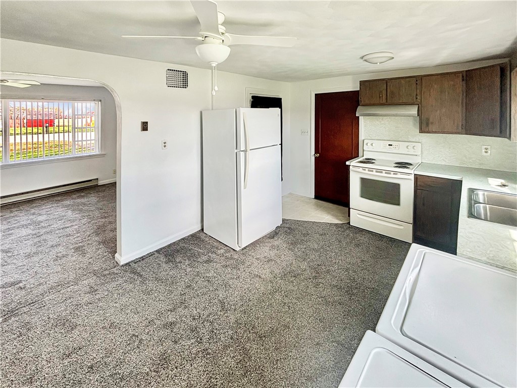 8411 Pitsburg-Laura Road Arcanum, OH 45304 - Photo 5 of 16 This cozy kitchen with essential appliances offers comfort and functionality.