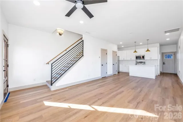 a view of a kitchen with a sink and wooden floor