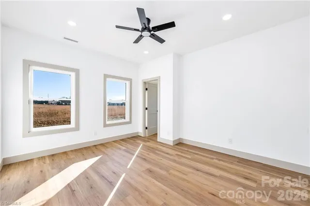 a view of a livingroom with a ceiling fan and window