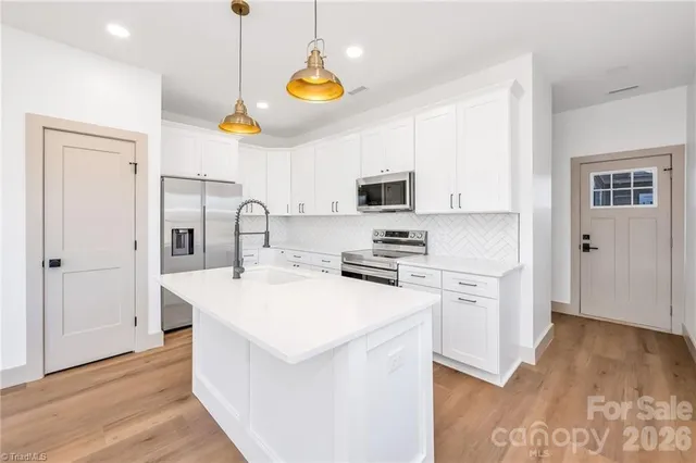 a kitchen with a sink appliances and cabinets