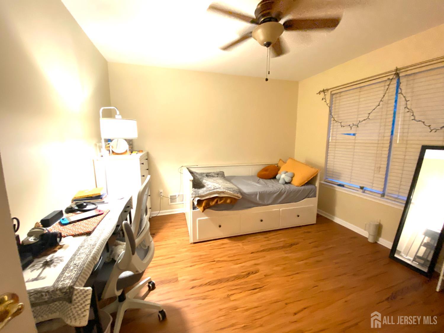 228 Hawthorne Road North Brunswick, NJ 08902 - Photo 13 of 23 a spacious bedroom with a bed and wooden floor