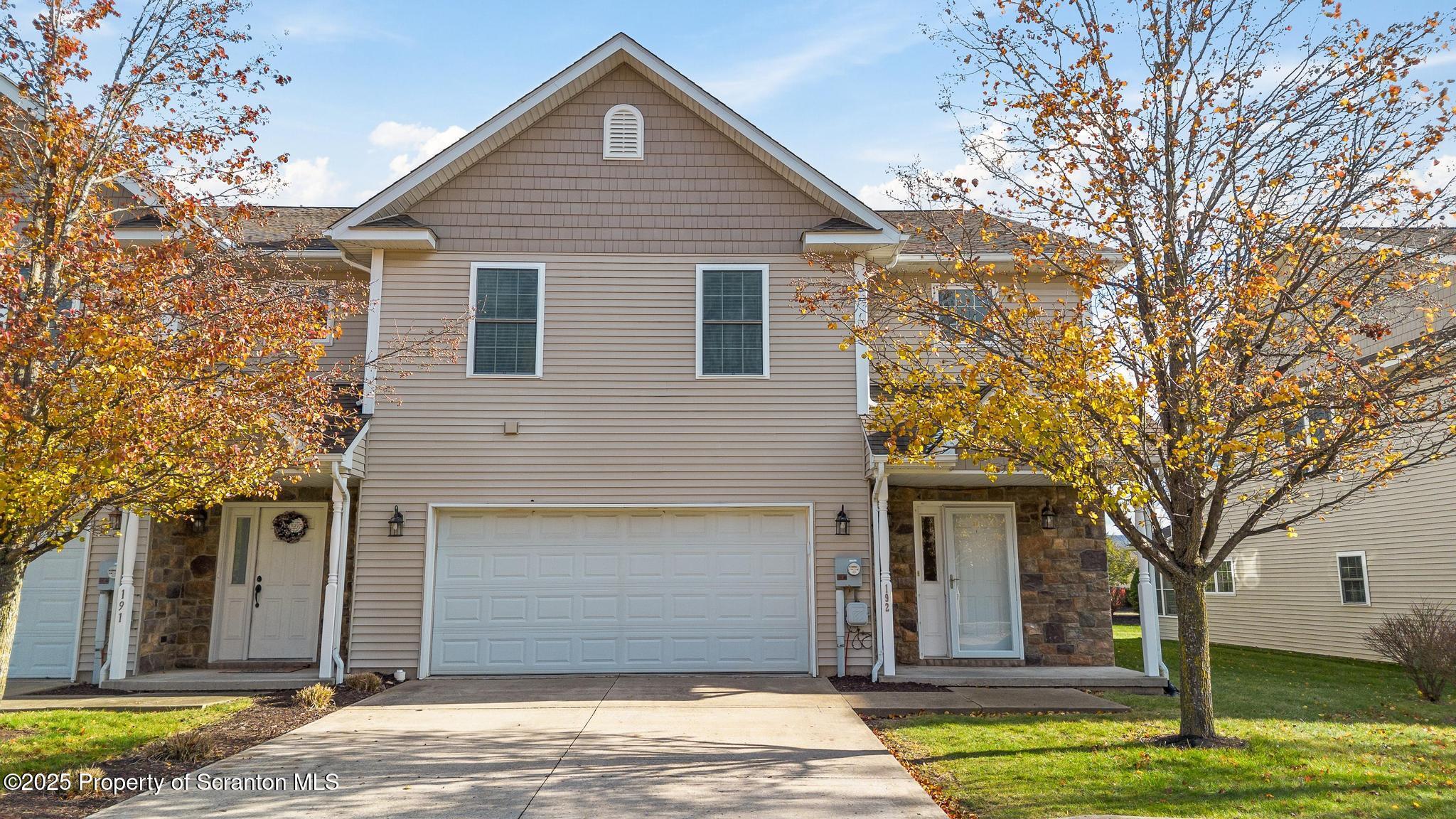a house that has a tree in front of the house