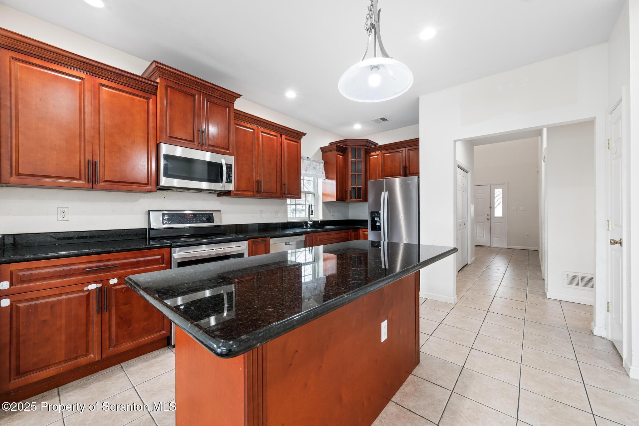 192 Shadow Wood Circle Archbald, PA 18403 - Photo 11 of 55 a kitchen with stainless steel appliances granite countertop a stove a sink and a microwave