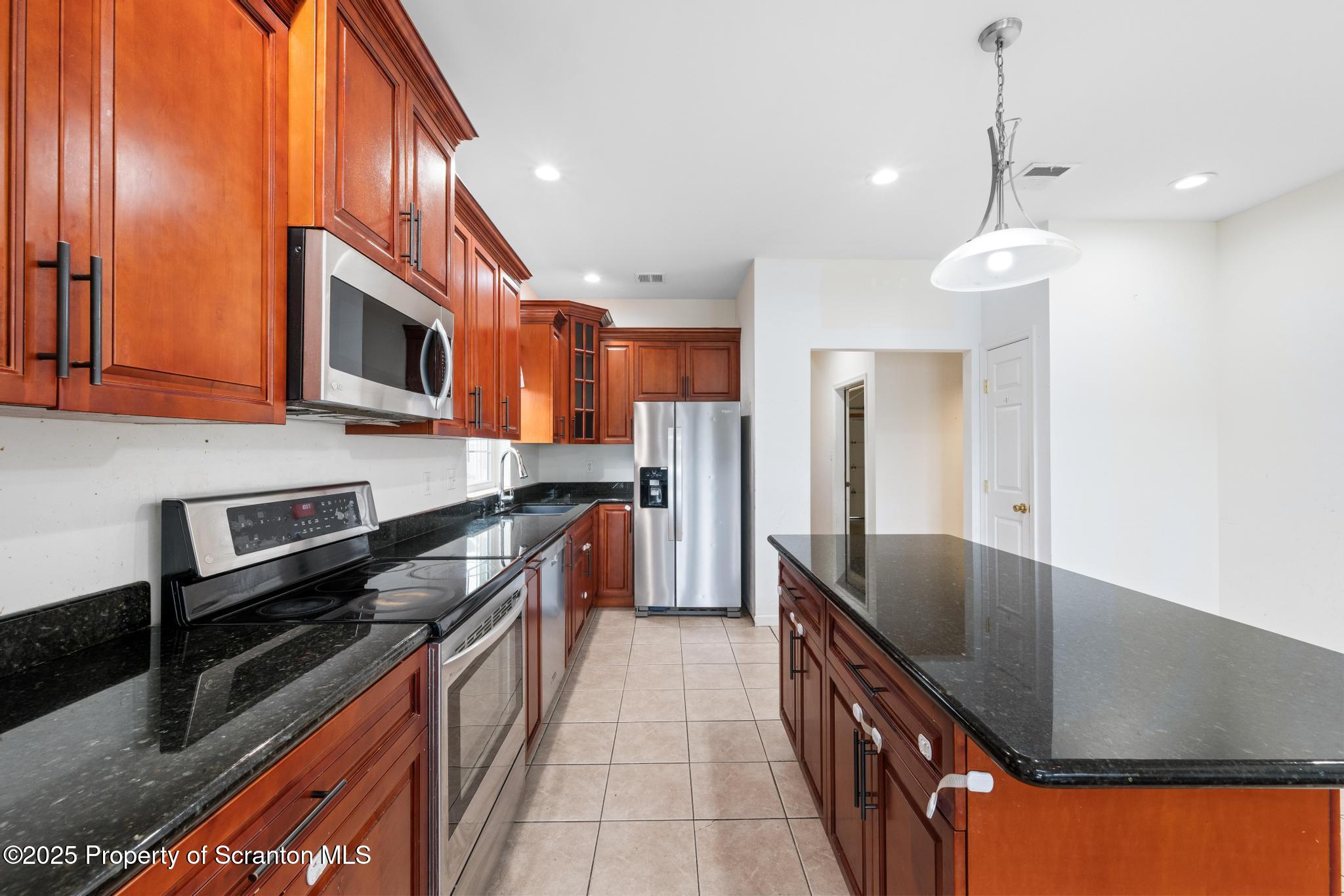 192 Shadow Wood Circle Archbald, PA 18403 - Photo 13 of 55 a kitchen with stainless steel appliances granite countertop a sink a stove and a refrigerator