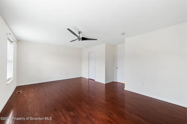 a view of a room with wooden floor