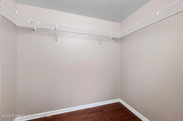 a view of a room with wooden floor