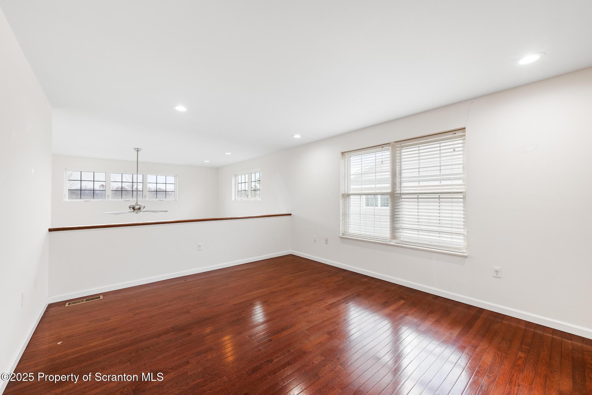 192 Shadow Wood Circle Archbald, PA 18403 - Photo 40 of 55 a view of an empty room with wooden floor and a window