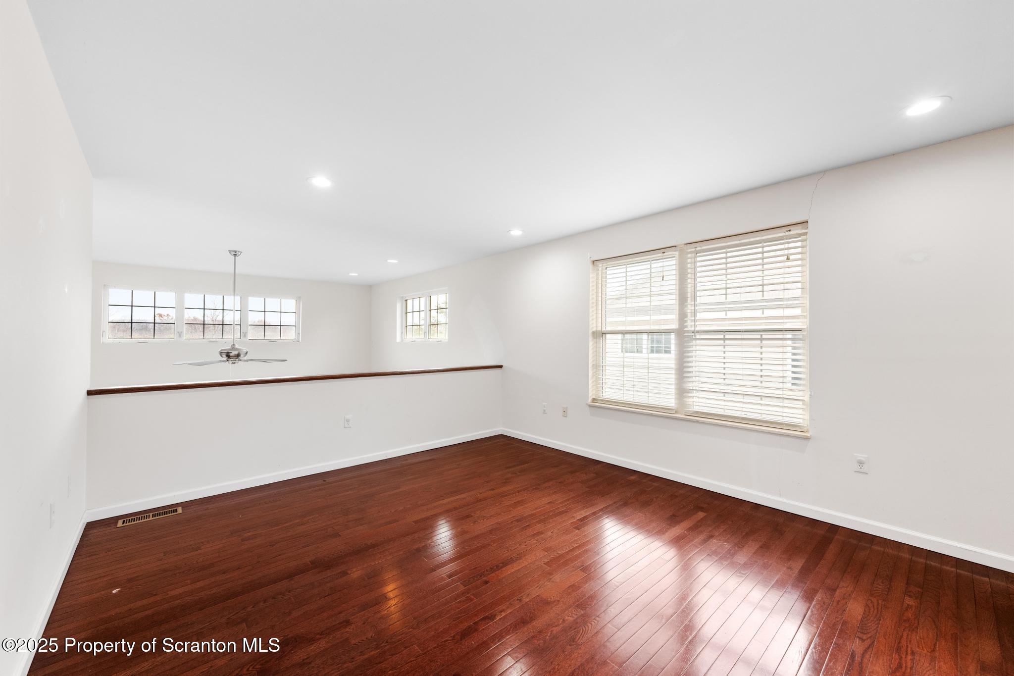 192 Shadow Wood Circle Archbald, PA 18403 - Photo 44 of 55 a view of an empty room with wooden floor and a window