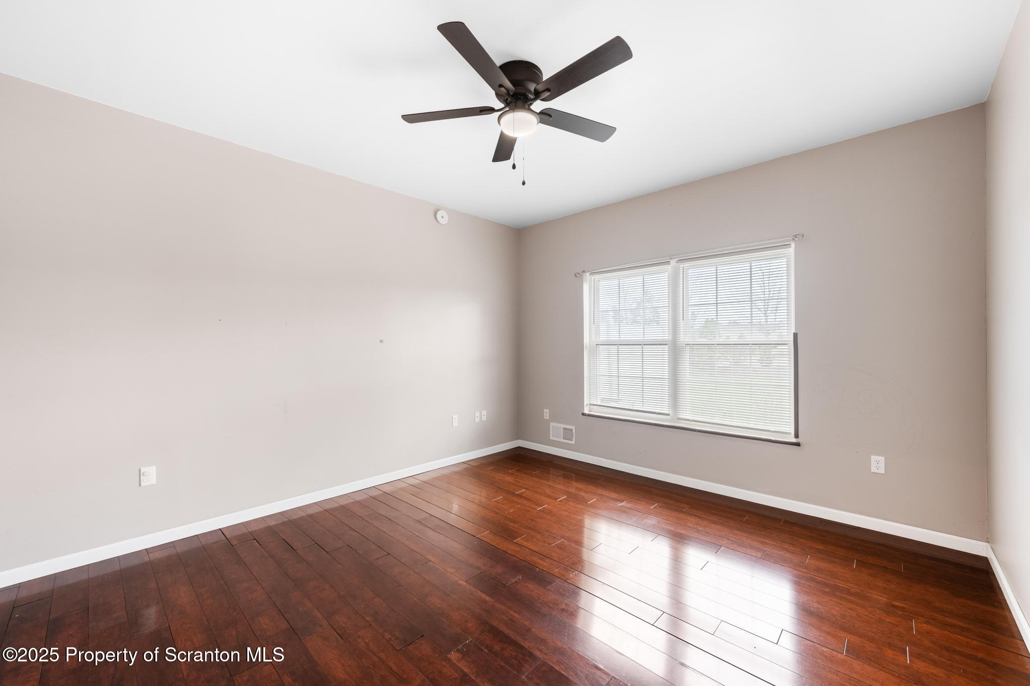 192 Shadow Wood Circle Archbald, PA 18403 - Photo 47 of 55 an empty room with wooden floor and windows