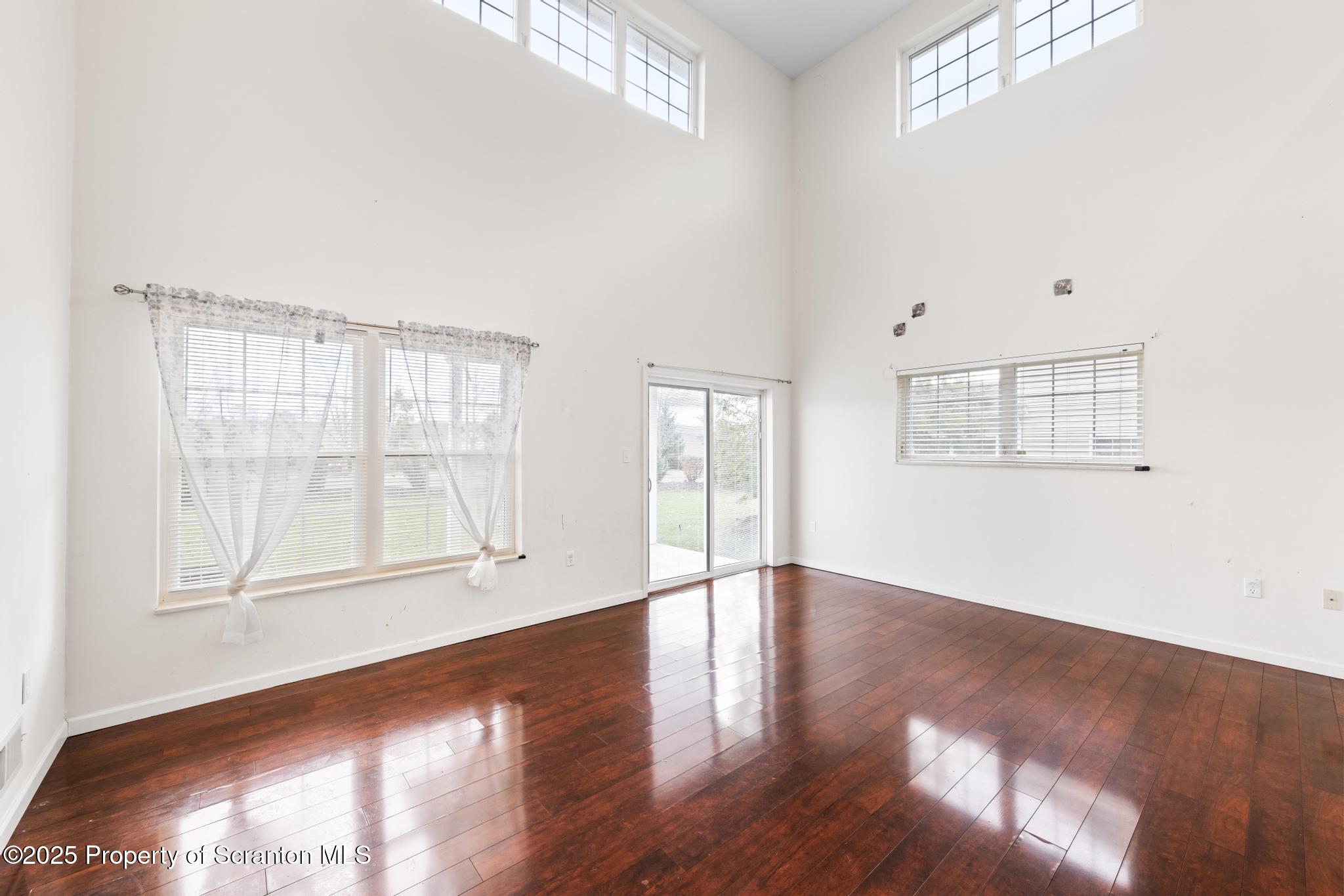 192 Shadow Wood Circle Archbald, PA 18403 - Photo 10 of 55 an empty room with wooden floor and windows