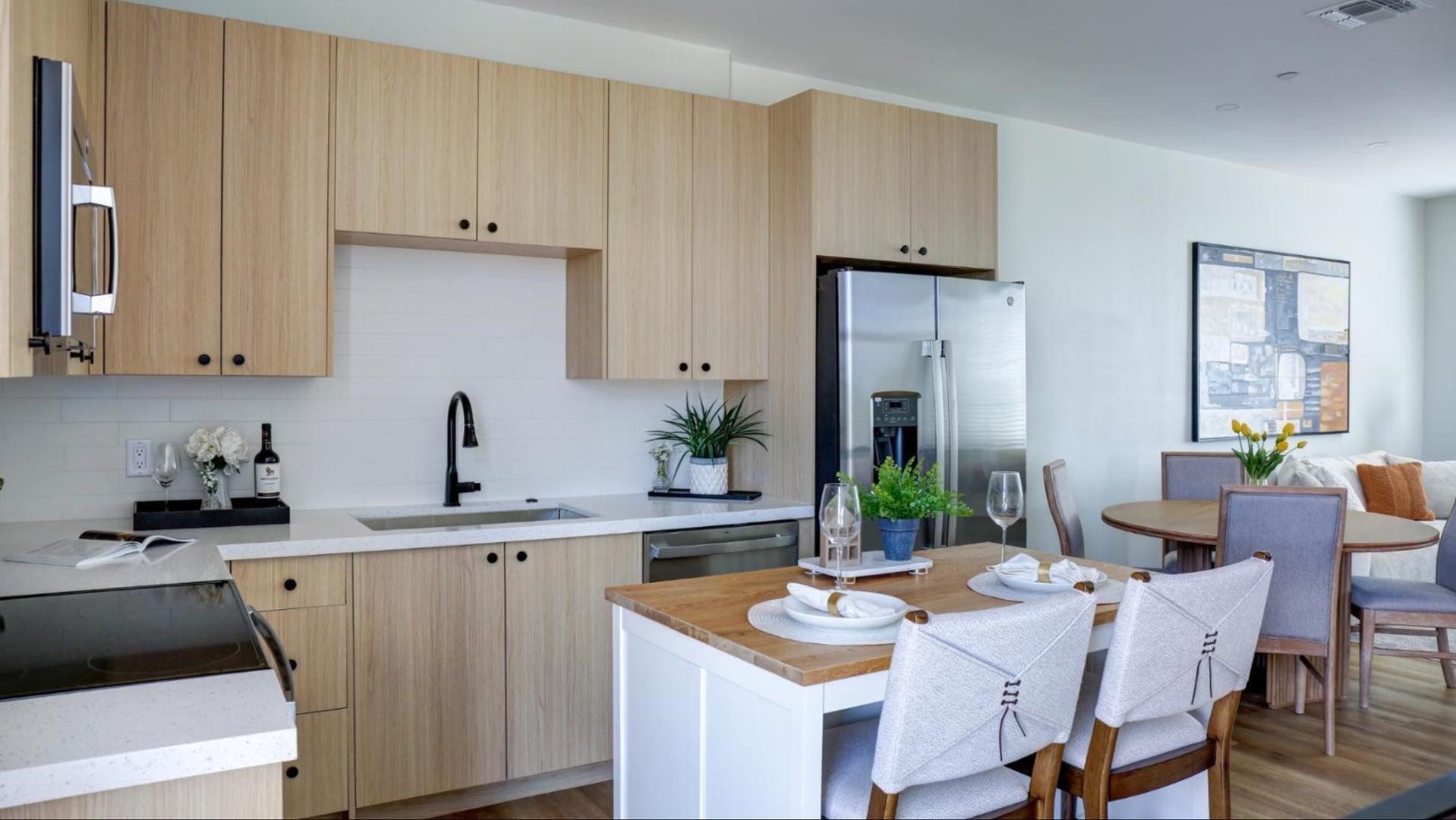 a kitchen with a sink cabinets and wooden floor