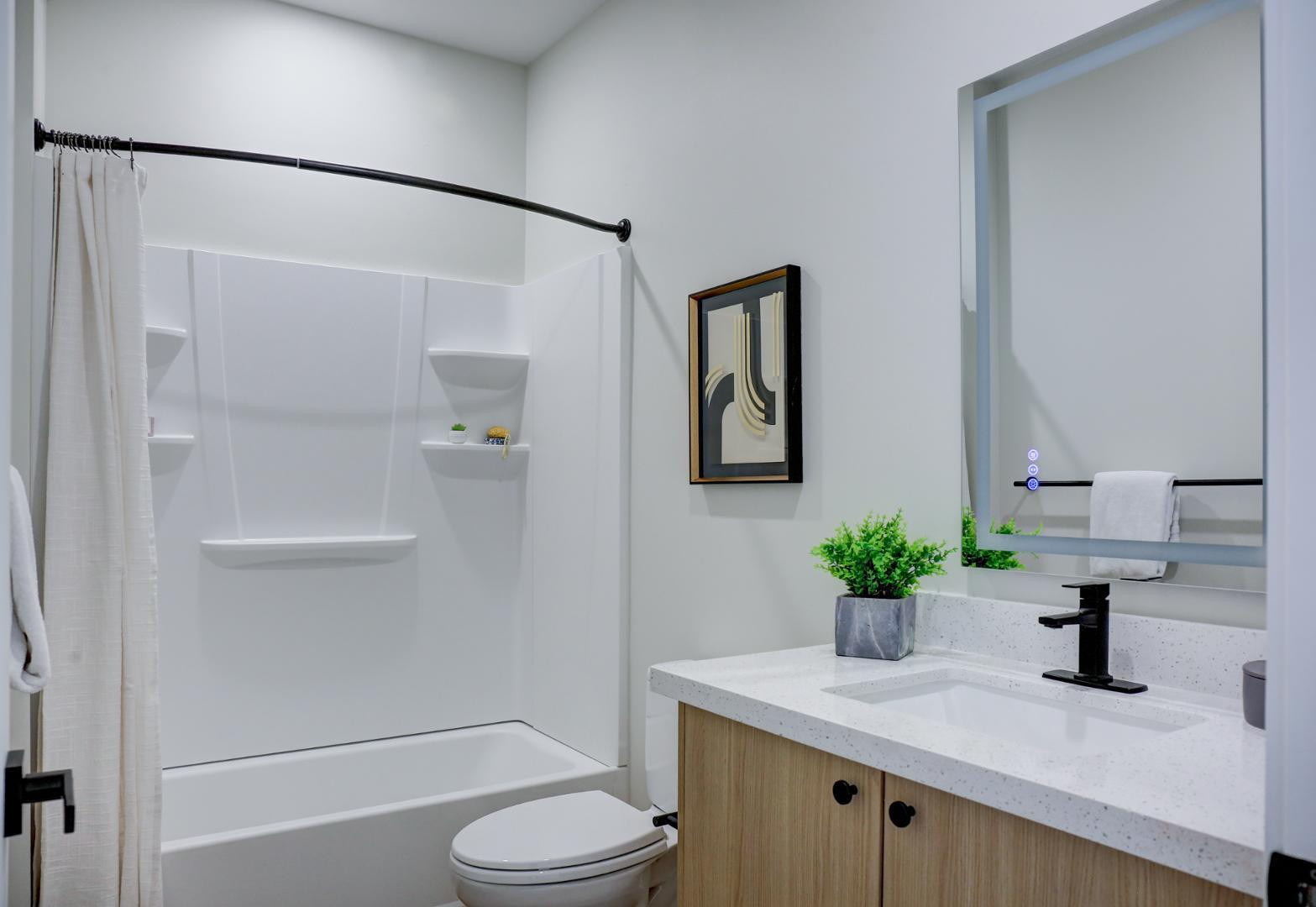630 North Power Road, Unit 114 Mesa, AZ 85205 - Photo 11 of 11 a bathroom with a granite countertop sink toilet and shower
