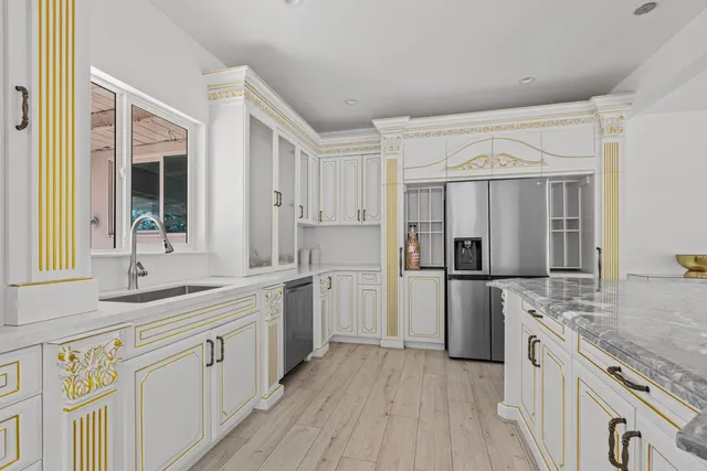 a kitchen with a sink stove and refrigerator