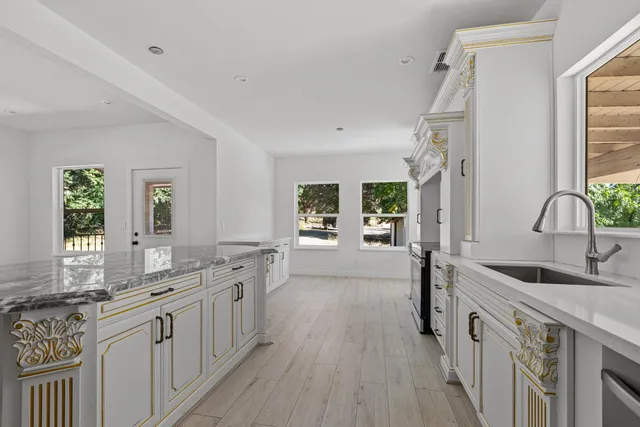 a large kitchen with a sink and cabinets
