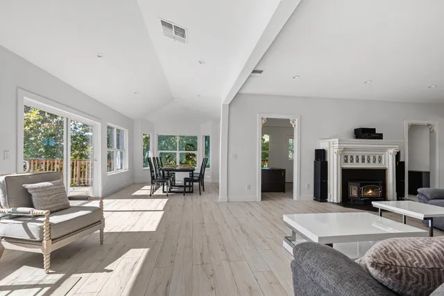 a living room with furniture large window and a fireplace