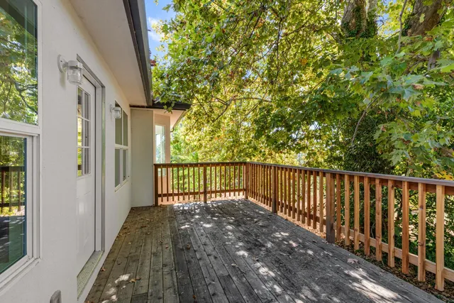 a view of a balcony with wooden floor