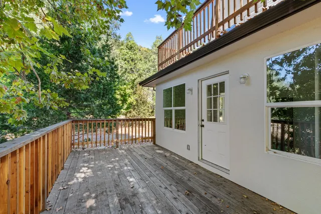 a view of balcony with wooden floor and fence