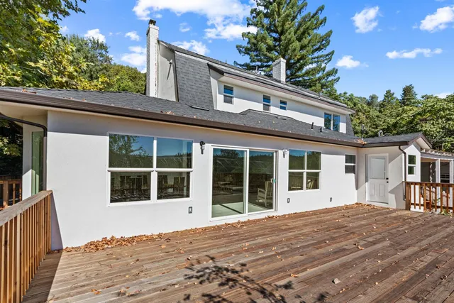 a view of balcony with wooden floor and fence
