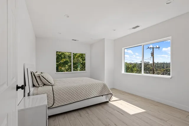 a bedroom with a bed and a window