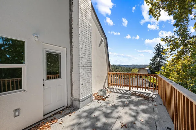 a view of balcony with wooden floor and fence