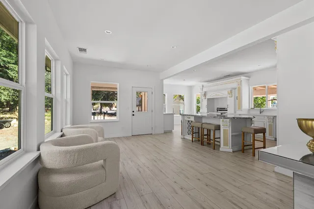 a living room with furniture and a wooden floor