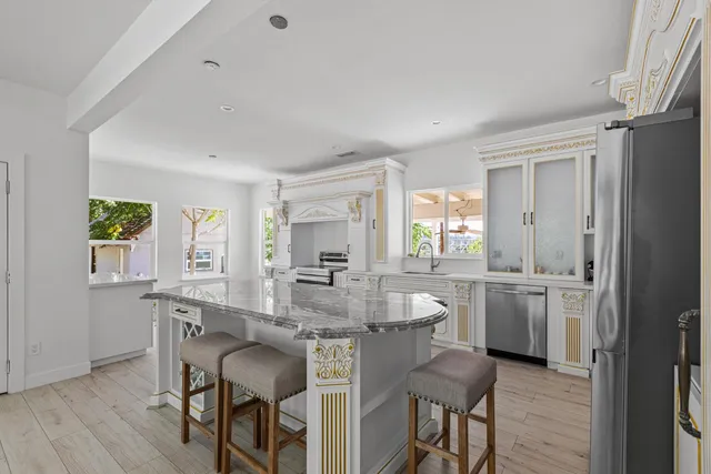 a dining room with kitchen island granite countertop furniture and wooden floor
