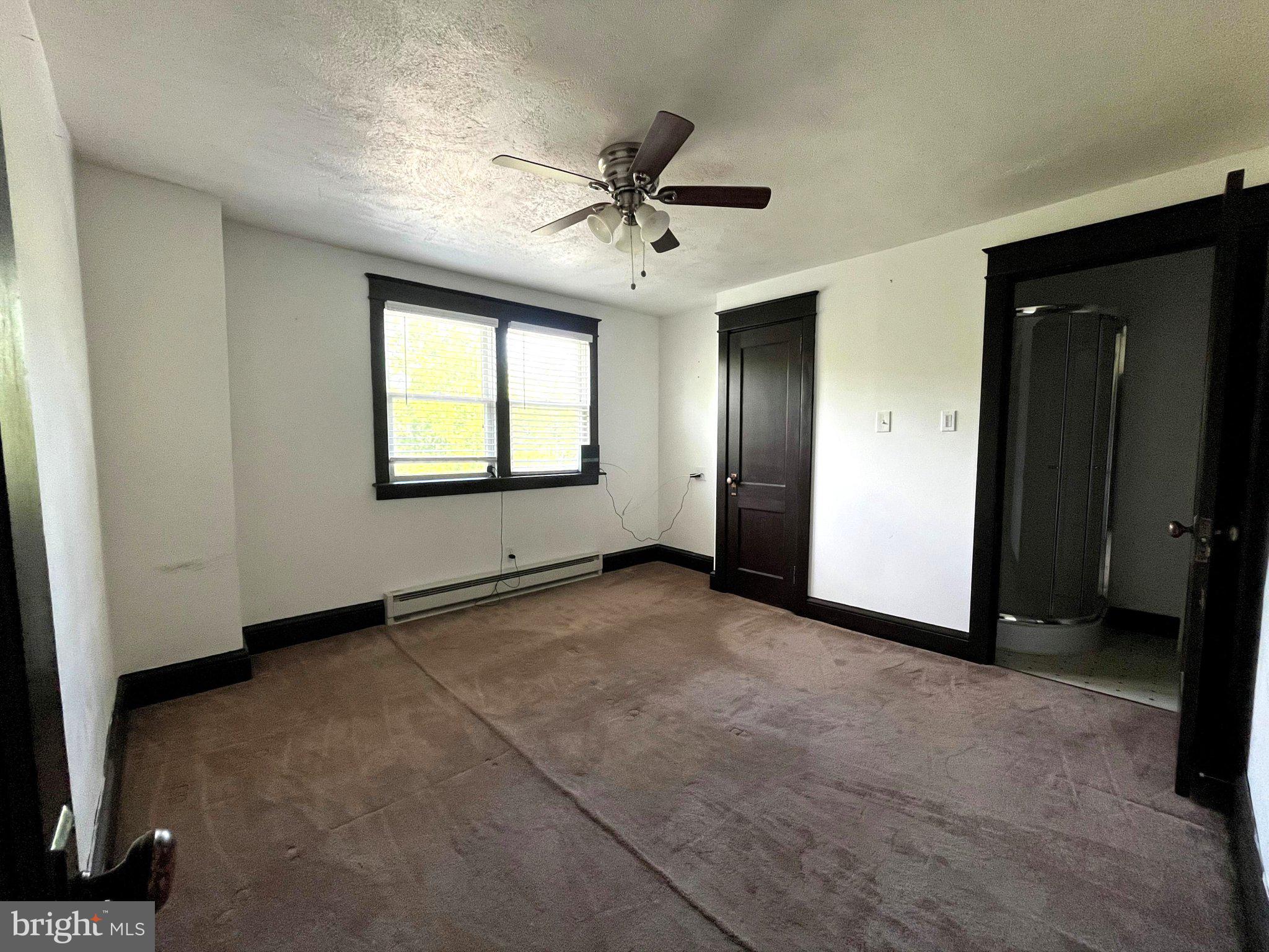 1660 Shimerville Road Emmaus, PA 18049 - Photo 16 of 26 an empty room with windows and fan