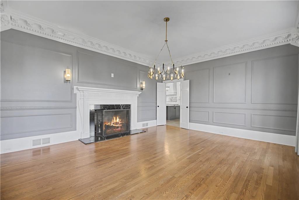1445 Hillside Drive Southwest Grayson, GA 30017 - Photo 12 of 85 a view of an empty room with wooden floor fireplace and a window