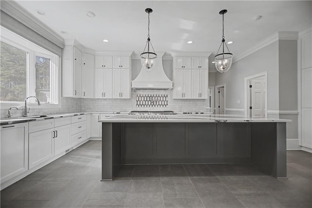 1445 Hillside Drive Southwest Grayson, GA 30017 - Photo 18 of 85 a kitchen with granite countertop a sink cabinets and stainless steel appliances