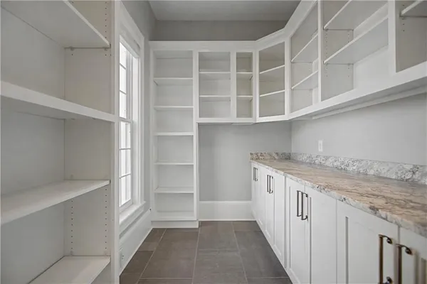 an empty room with wooden floor and ceiling fan