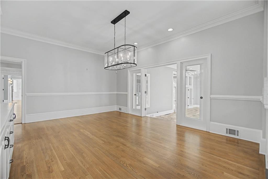 1445 Hillside Drive Southwest Grayson, GA 30017 - Photo 30 of 85 a view of an empty room with wooden floor closet and a window