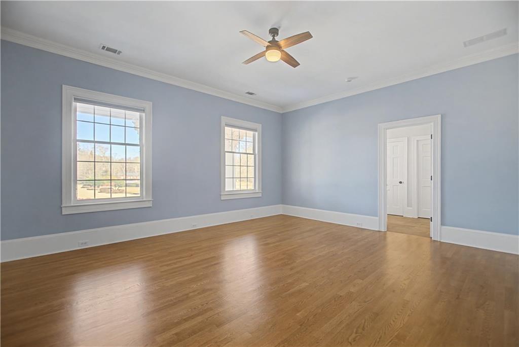 1445 Hillside Drive Southwest Grayson, GA 30017 - Photo 41 of 85 a view of an empty room with window and wooden floor