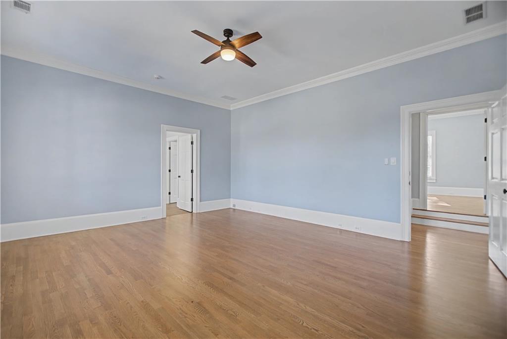 1445 Hillside Drive Southwest Grayson, GA 30017 - Photo 42 of 85 an empty room with wooden floor and ceiling fan