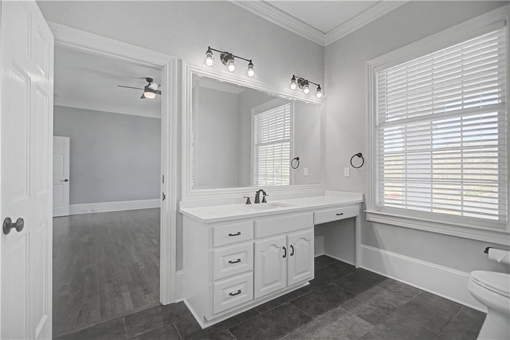 1445 Hillside Drive Southwest Grayson, GA 30017 - Photo 43 of 85 a spacious bathroom with a double vanity sink a large mirror a bathtub and window
