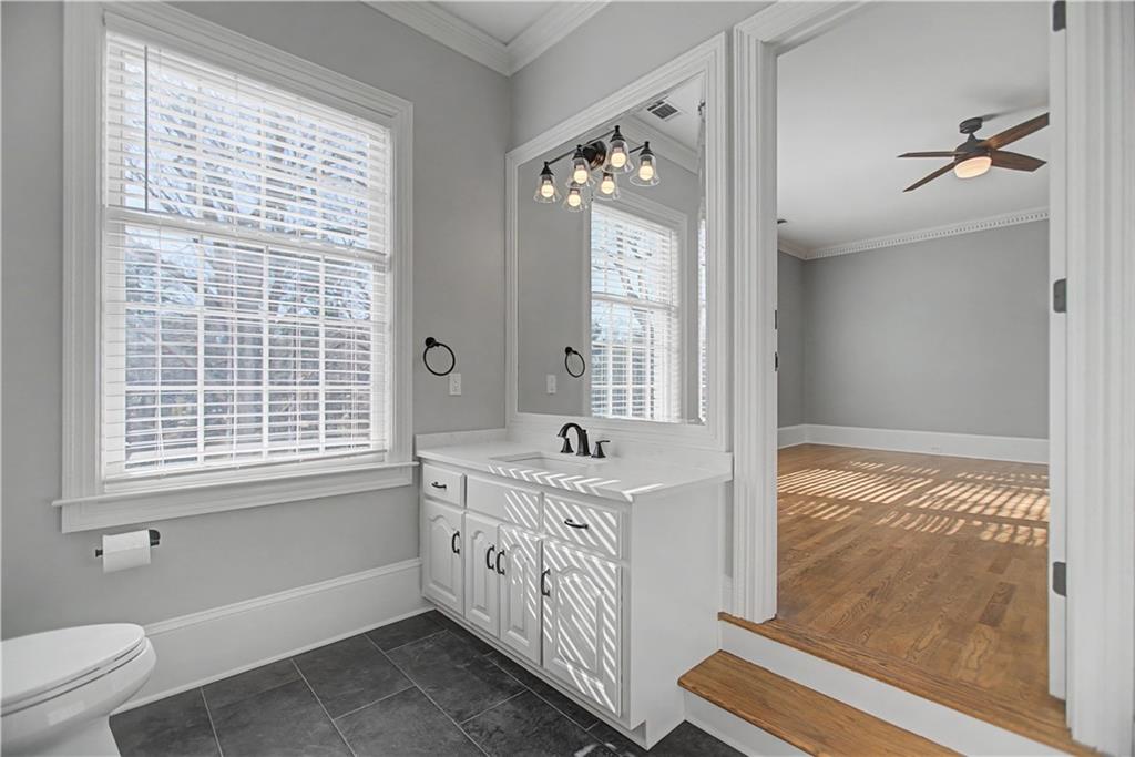 1445 Hillside Drive Southwest Grayson, GA 30017 - Photo 46 of 85 a bathroom with a sink a large mirror and a bathtub