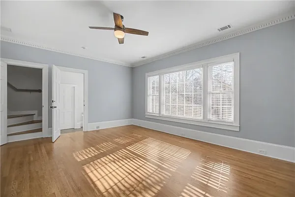 a living room with stainless steel appliances furniture a fireplace and a large window