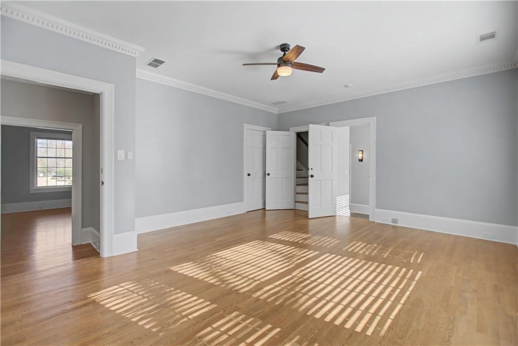 1445 Hillside Drive Southwest Grayson, GA 30017 - Photo 48 of 85 a view of empty room with wooden floor and fan