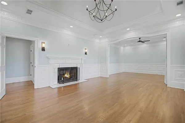 a front view of house with yard and trees in the background