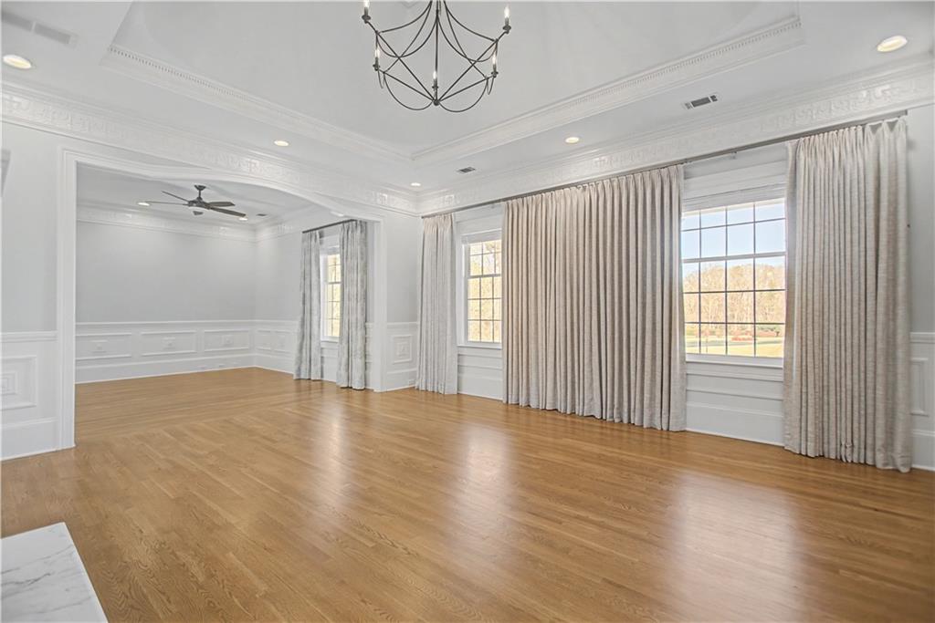1445 Hillside Drive Southwest Grayson, GA 30017 - Photo 50 of 85 a view of an empty room with wooden floor and a window