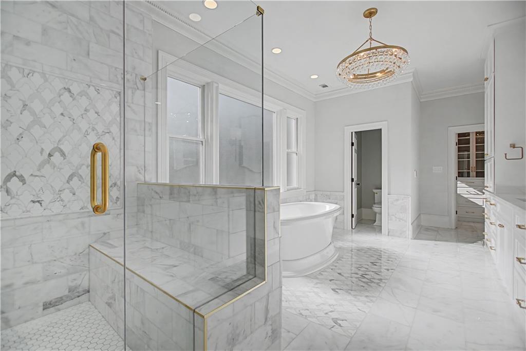 1445 Hillside Drive Southwest Grayson, GA 30017 - Photo 54 of 85 a bathroom with a granite countertop sink a toilet and bathtub