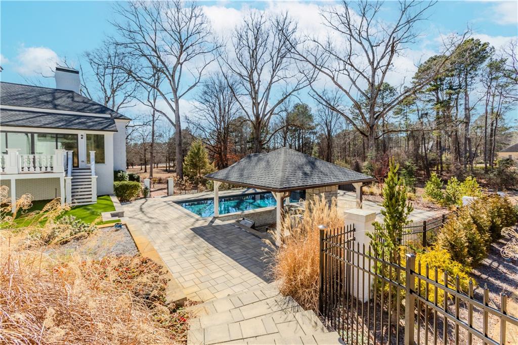 1445 Hillside Drive Southwest Grayson, GA 30017 - Photo 72 of 85 a view of a patio with table and chairs under an umbrella
