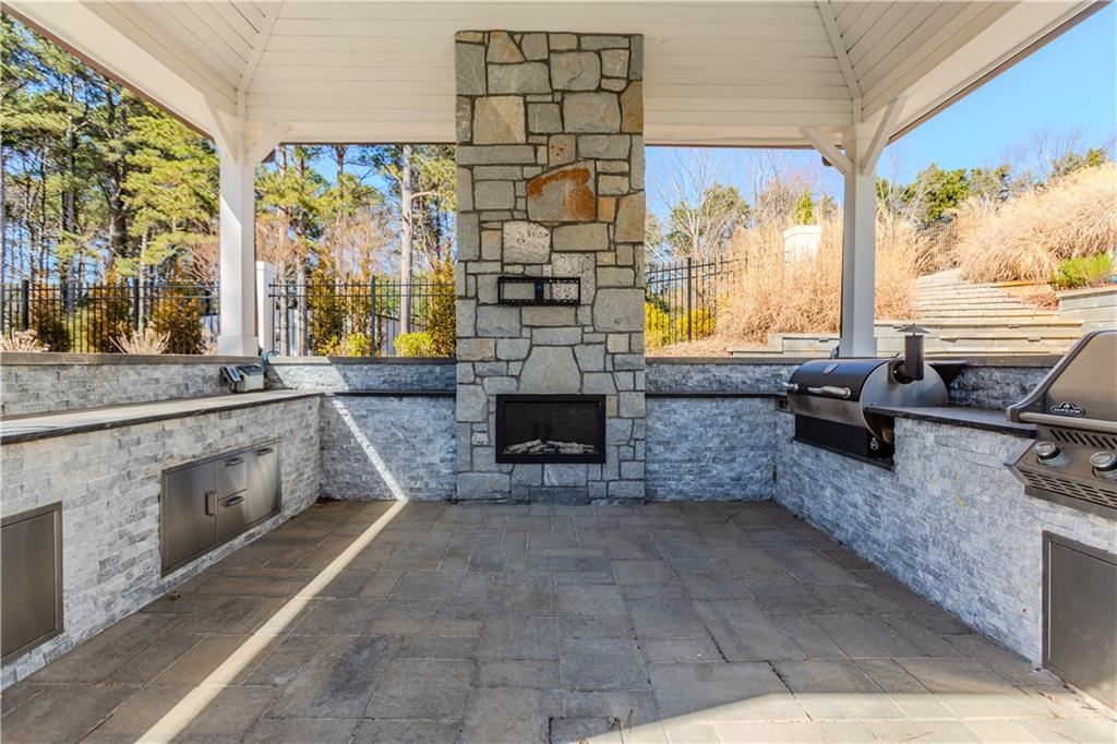 1445 Hillside Drive Southwest Grayson, GA 30017 - Photo 77 of 85 a living room with stainless steel appliances furniture a fireplace and a large window