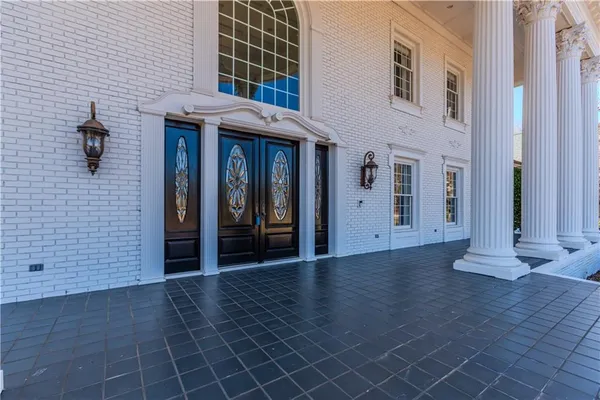 a view of an empty room with wooden floor fireplace and a window