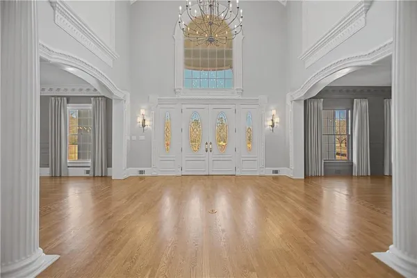 a view of a big room with chandelier and windows